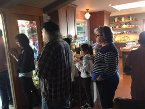 Overflow crowd listening from inside the Fadelli home
